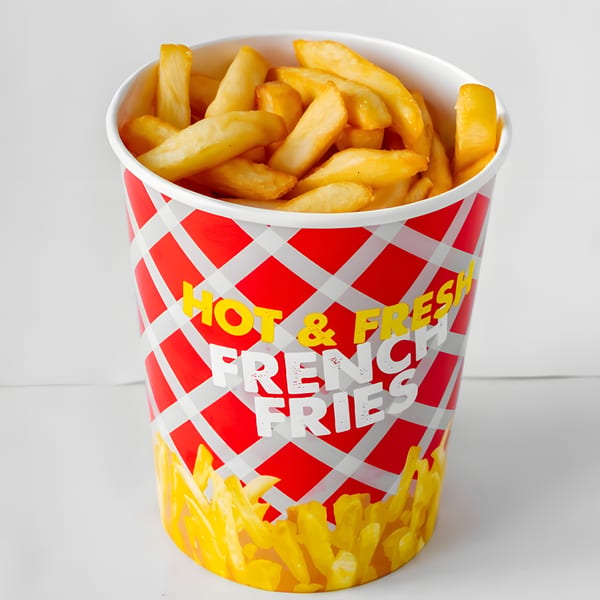 A red and white checkered cup overflowing with golden, crispy French fries.