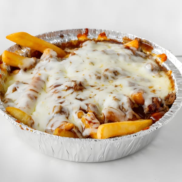 Cheesesteak fries, a Soprano's Pizza specialty, in a foil container, topped with melted cheese and meat.