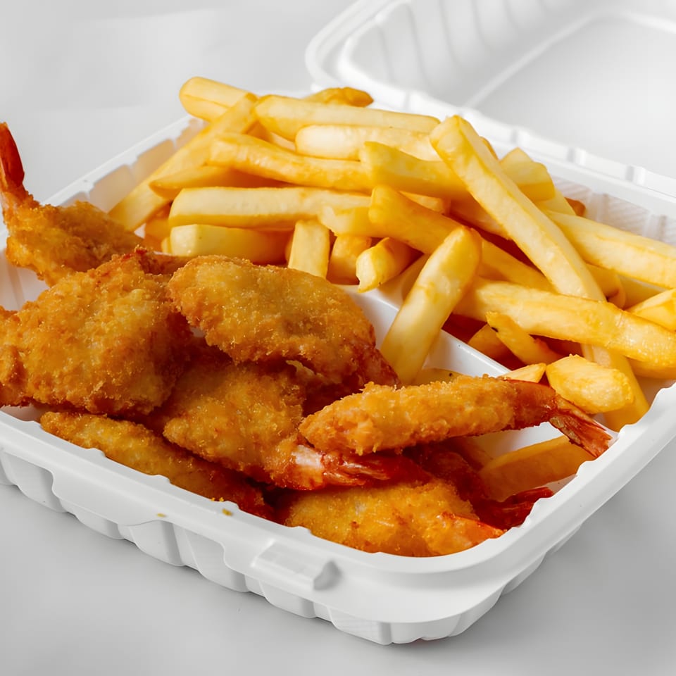 Crispy fried shrimp and golden french fries in a white takeout container from Soprano's Pizza.